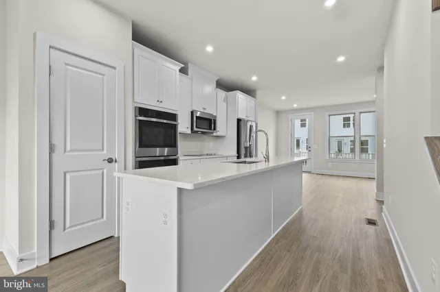 a kitchen with counter top space cabinets and stainless steel appliances