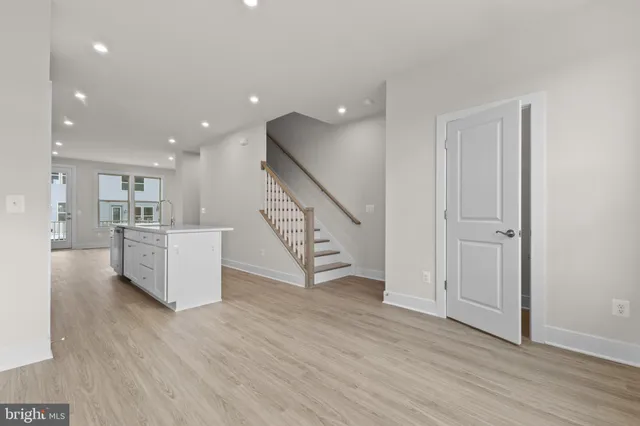 a view of a kitchen with furniture and wooden floor
