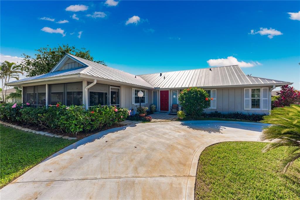 5712 Southeast Miles Grant Road Stuart, FL 34997 - Photo 8 of 28 a front view of a house with a yard