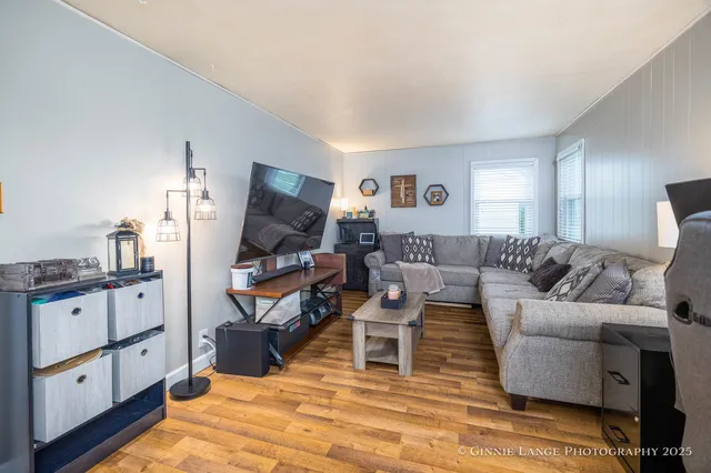 a living room with furniture a flat screen tv and a rug
