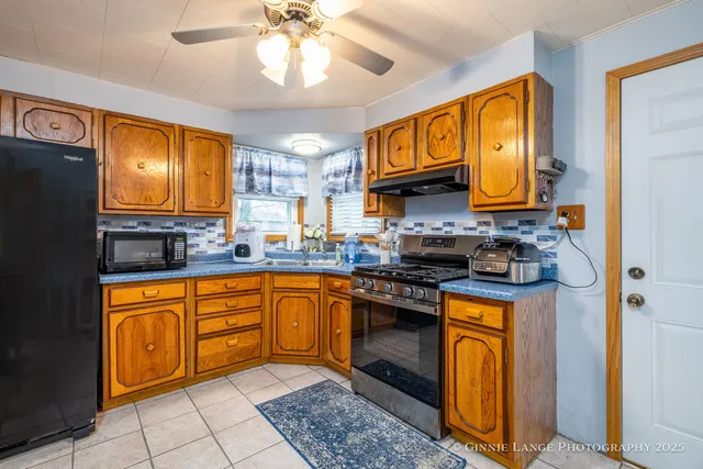 a kitchen with stainless steel appliances granite countertop a stove sink and cabinets
