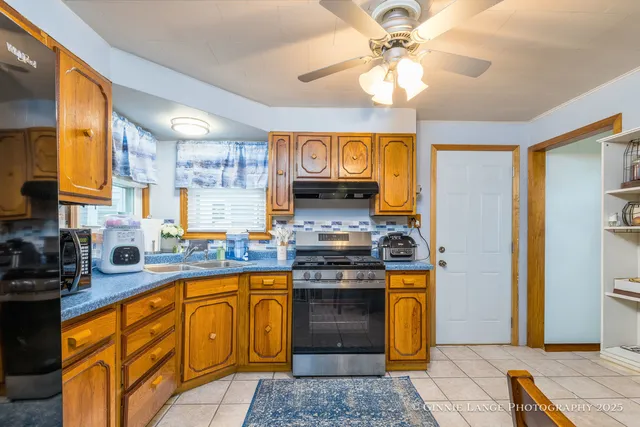 a kitchen with stainless steel appliances granite countertop a stove a sink and a refrigerator