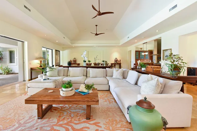 a living room with furniture a flat screen tv and a dining table