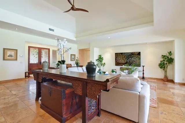 a kitchen with a dining table chairs cabinets and stainless steel appliances