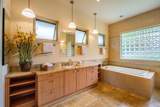 a bathroom with a tub sink and mirror