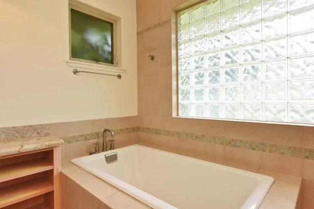 a bathroom with a double vanity sink and a large mirror