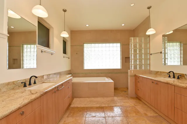 a bathroom with a sink vanity granite and toilet