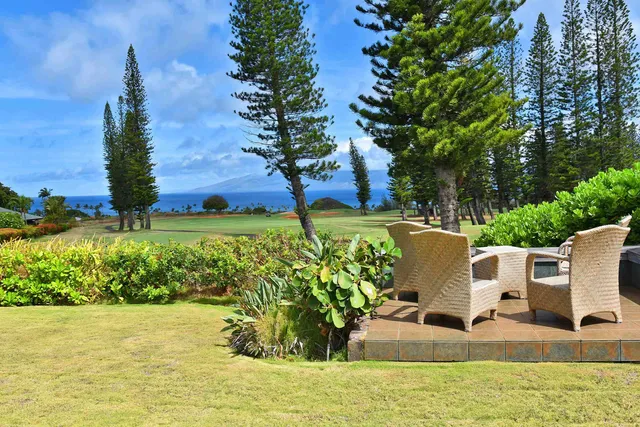 a view of yard with seating area and trees around