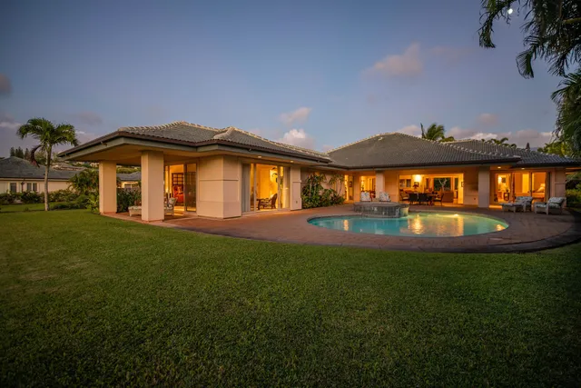 a backyard of a house with table and chairs