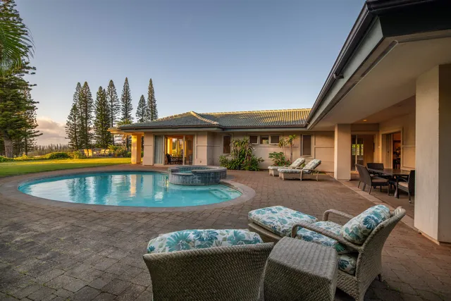 a view of swimming pool with outdoor seating and a yard