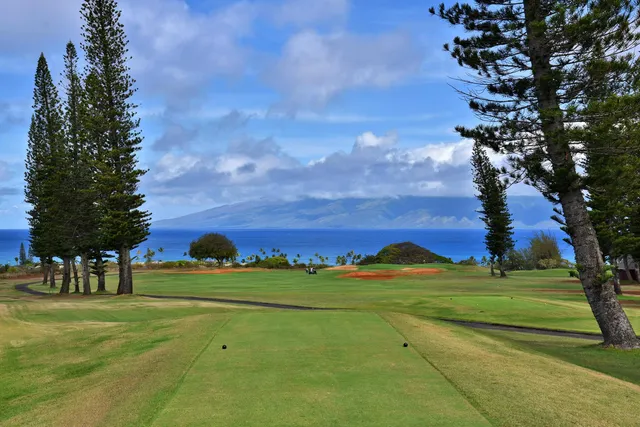 a living room with furniture and view of kitchen
