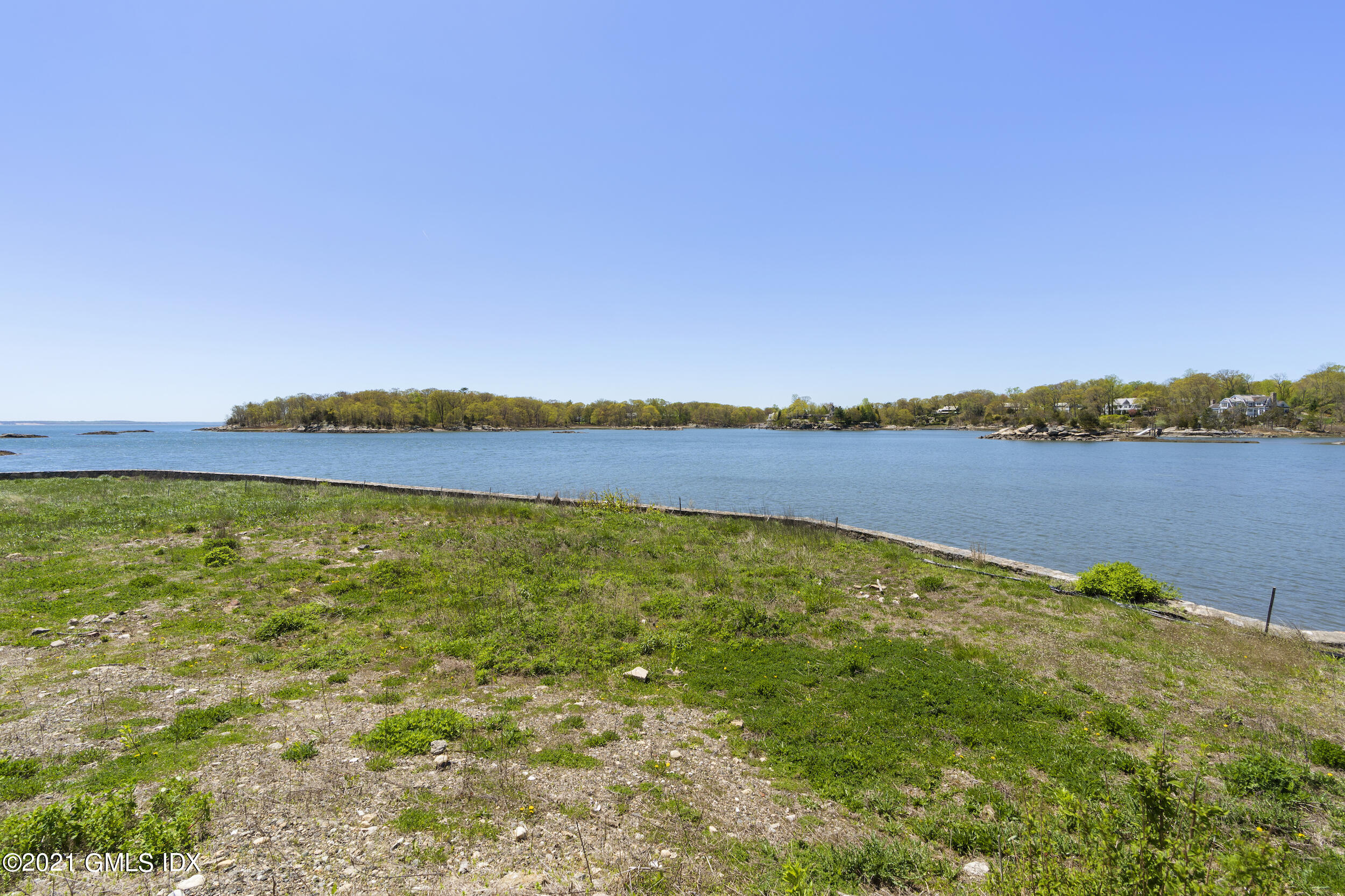 122 Delafield Island Road Darien, CT 06820 - Photo 20 of 34 a view of a lake with houses in the back