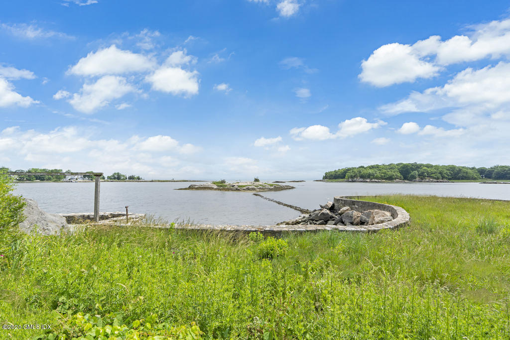 122 Delafield Island Road Darien, CT 06820 - Photo 28 of 34 a view of a lake with houses in the back