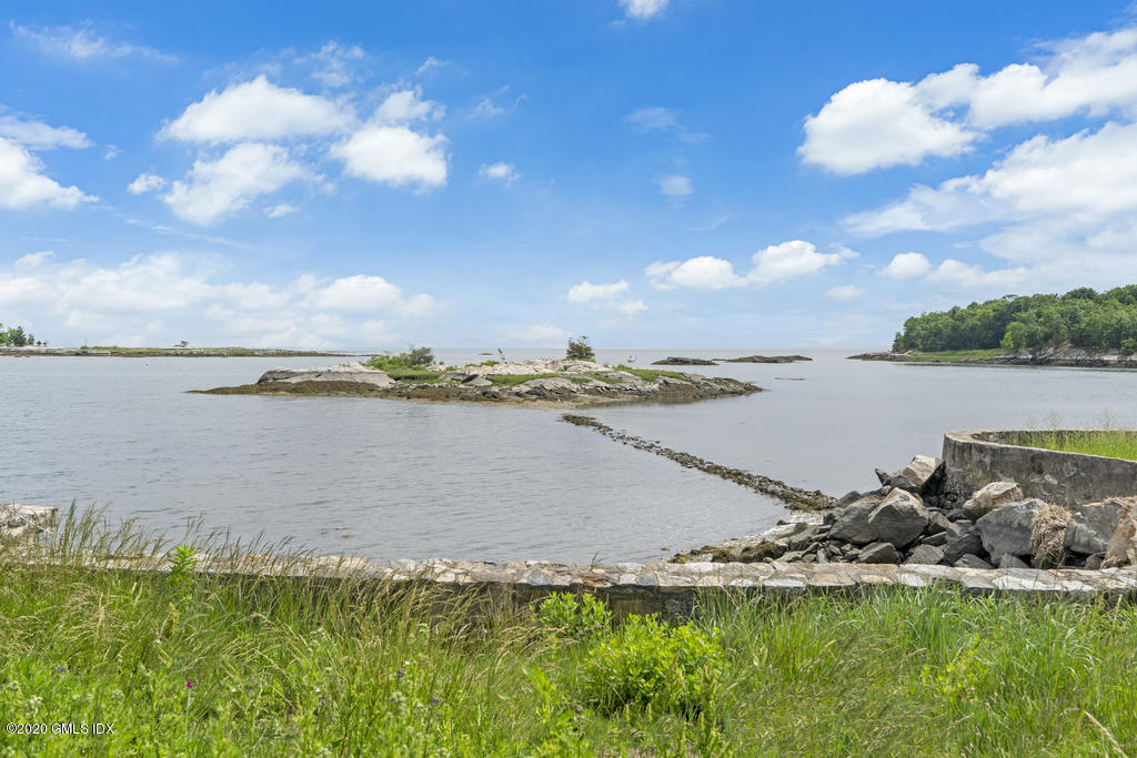 122 Delafield Island Road Darien, CT 06820 - Photo 31 of 34 a view of a lake with lawn chairs
