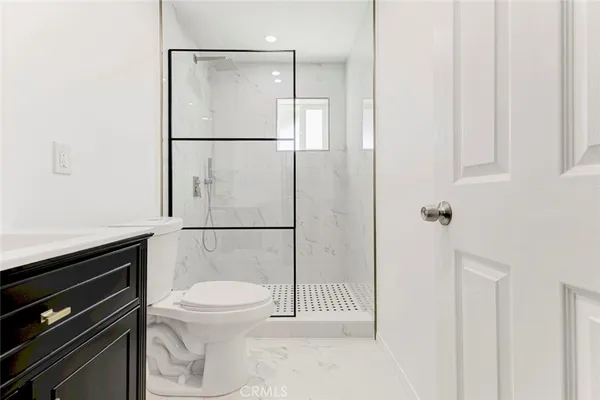 a bathroom with a toilet a sink and a shower