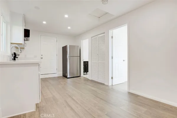 a view of a kitchen with a sink and a refrigerator