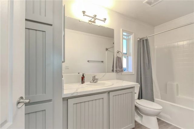 a bathroom with a sink toilet and shower