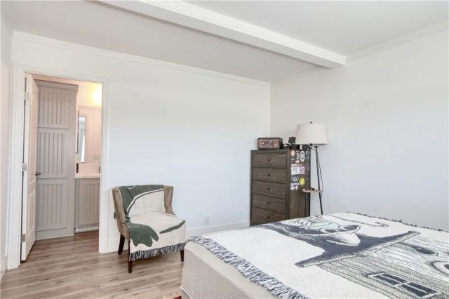 a bedroom with a bed and a chair