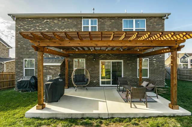 a view of a house with backyard porch and sitting area