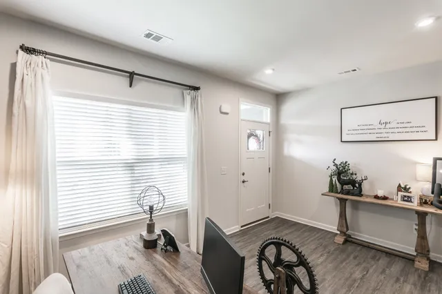 a view of a workspace with furniture and a window