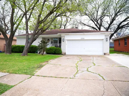 a front view of a house with a yard and a garage