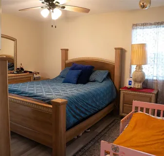 a bedroom with a bed and window