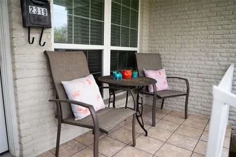 a balcony with table and chairs