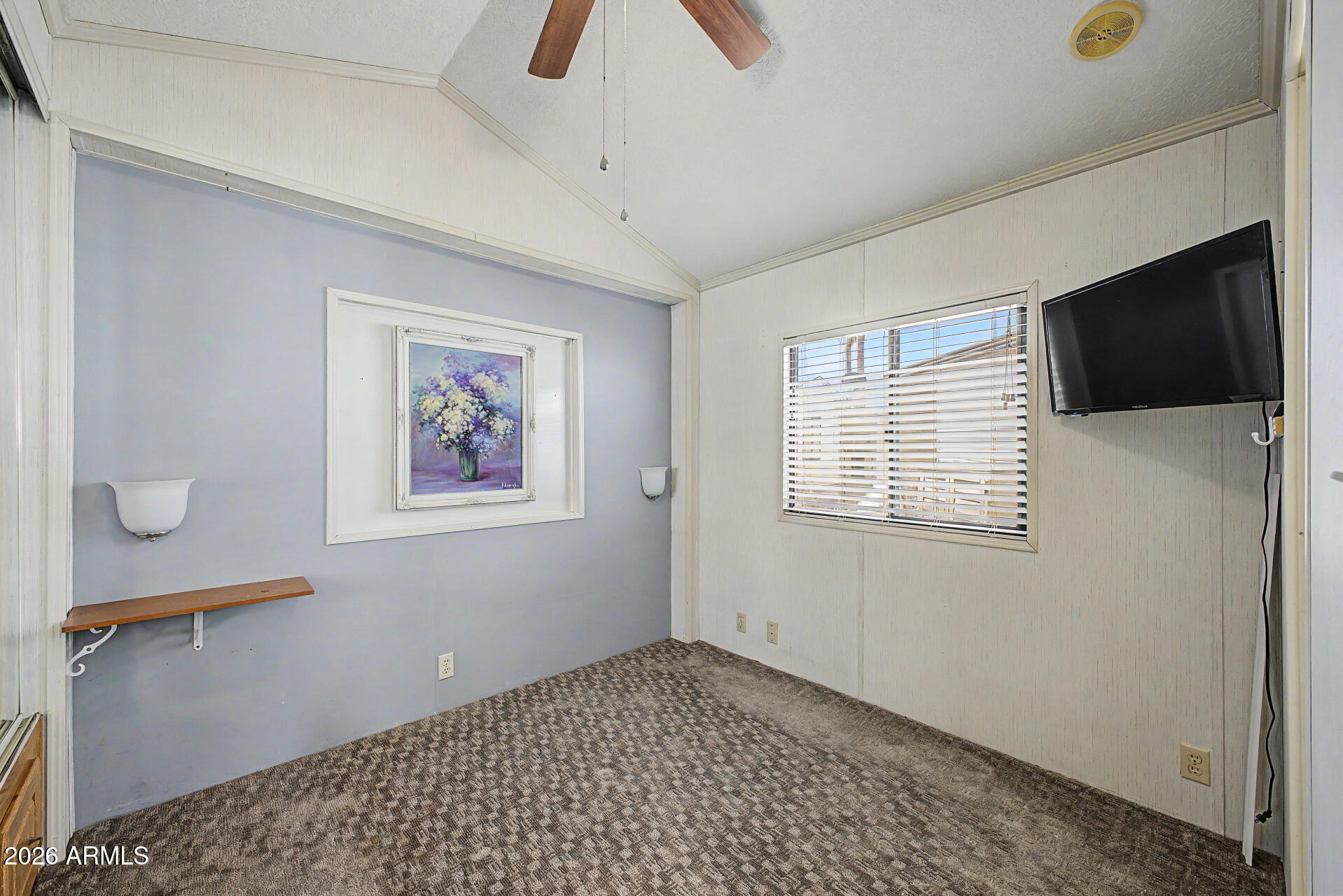 7750 East Broadway Road, Unit 560 Mesa, AZ 85208 - Photo 8 of 18 a view of an empty room with a window and a flat screen tv