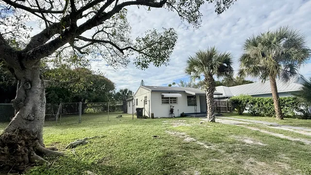 a view of a house with a tree in a yard