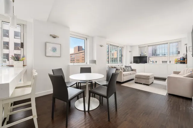a view of a dining room with furniture and wooden floor
