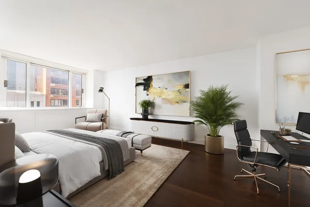 a bedroom with a large bed and a potted plant