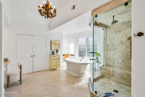 a spacious bathroom with a double vanity sink a mirror and a shower