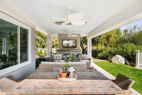 a view of a patio with couches chairs and a yard