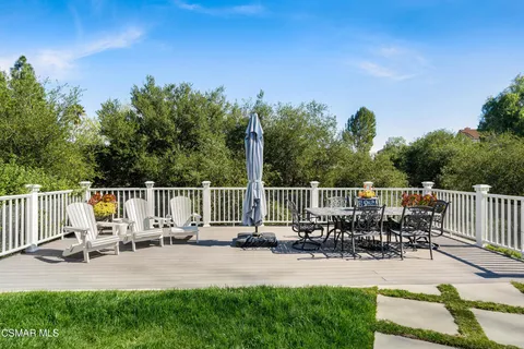 an aerial view of a house with garden space and seating area