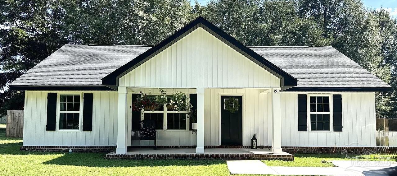 1910 West Kingsfield Road Cantonment, FL 32533 - Photo 1 of 8 a view of a house with yard and sitting area
