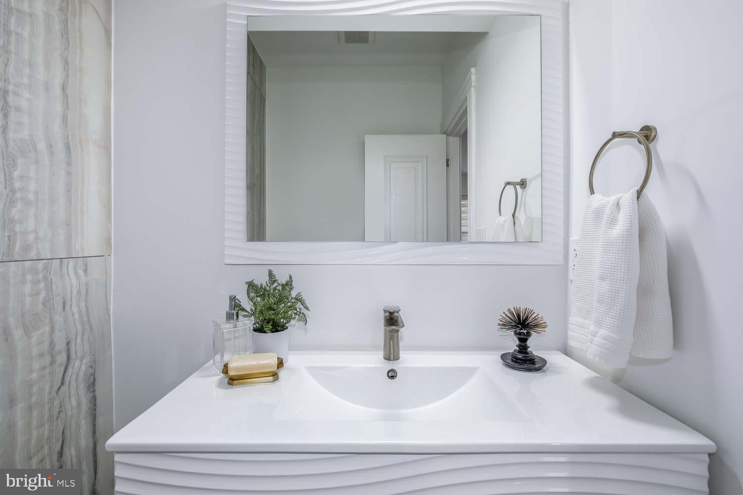 317 3rd Street Southeast, Unit 26 Washington, DC 20003 - Photo 7 of 18 a bathroom with a sink and a mirror