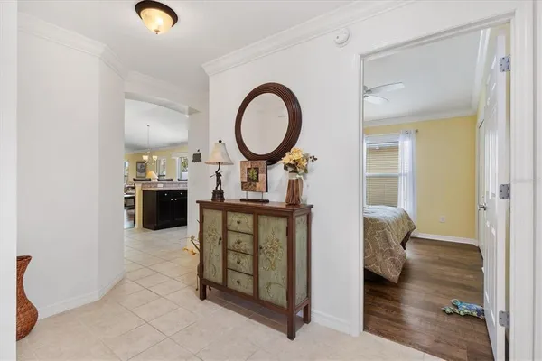 a living room with furniture a mirror and a wooden floor