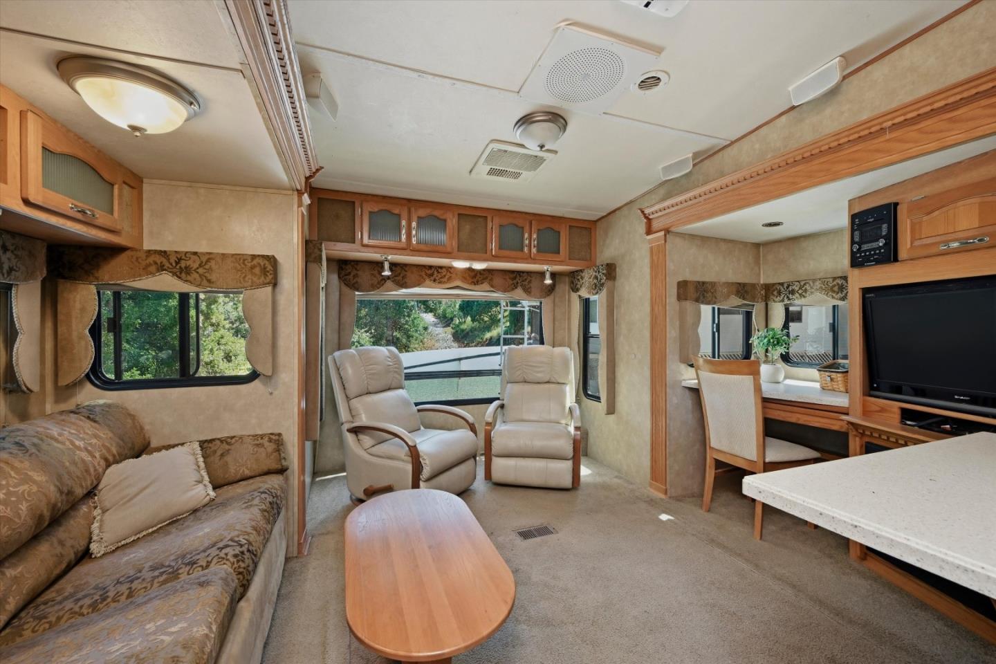 5156 Lake Road Lower Lake, CA 95457 - Photo 9 of 27 a living room with furniture a flat screen tv and floor to ceiling window