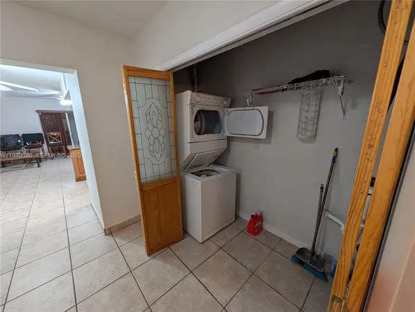 a view of storage and utility room with two washing machine