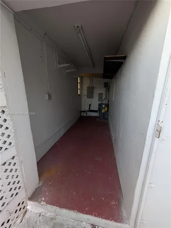 a view of a hallway with wooden walls