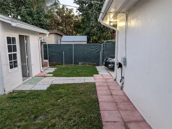 a view of backyard with potted plants