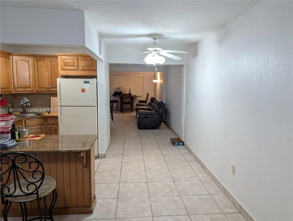 a kitchen with a refrigerator and a stove