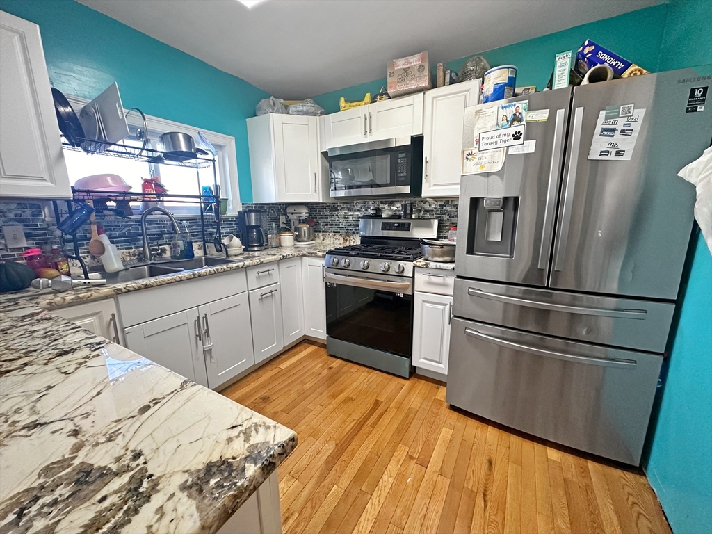 802 2nd Street Fall River, MA 02721 - Photo 5 of 12 a kitchen with granite countertop a sink appliances and cabinets