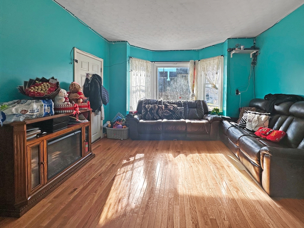 802 2nd Street Fall River, MA 02721 - Photo 8 of 12 a living room with furniture and a wooden floor