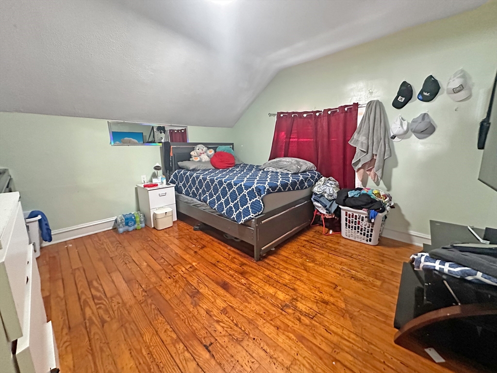 802 2nd Street Fall River, MA 02721 - Photo 9 of 12 a bedroom with a bed and window