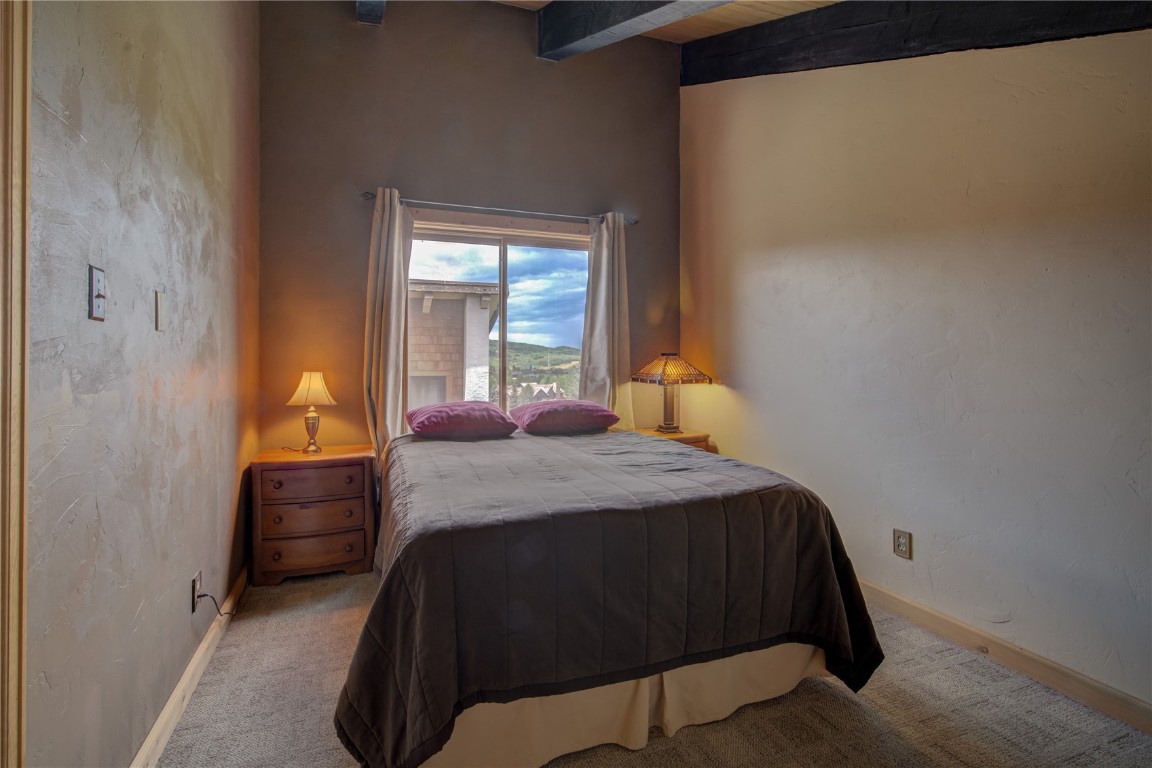 1945 Cornice Road, Unit 2431 Steamboat Springs, CO 80487 - Photo 11 of 24 a bedroom with a bed and a window