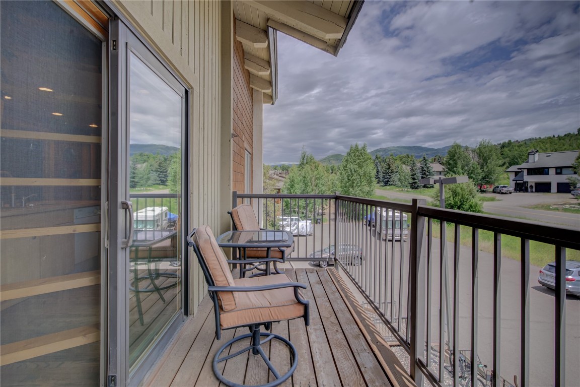 1945 Cornice Road, Unit 2431 Steamboat Springs, CO 80487 - Photo 14 of 24 a view of a balcony with chair and wooden floor