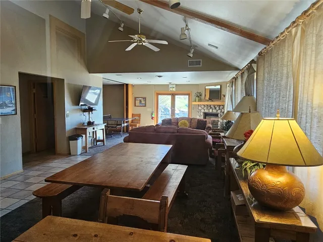 a living room with furniture a chandelier and a wooden floor