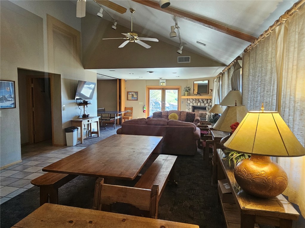 1945 Cornice Road, Unit 2431 Steamboat Springs, CO 80487 - Photo 22 of 24 a living room with furniture a chandelier and a wooden floor