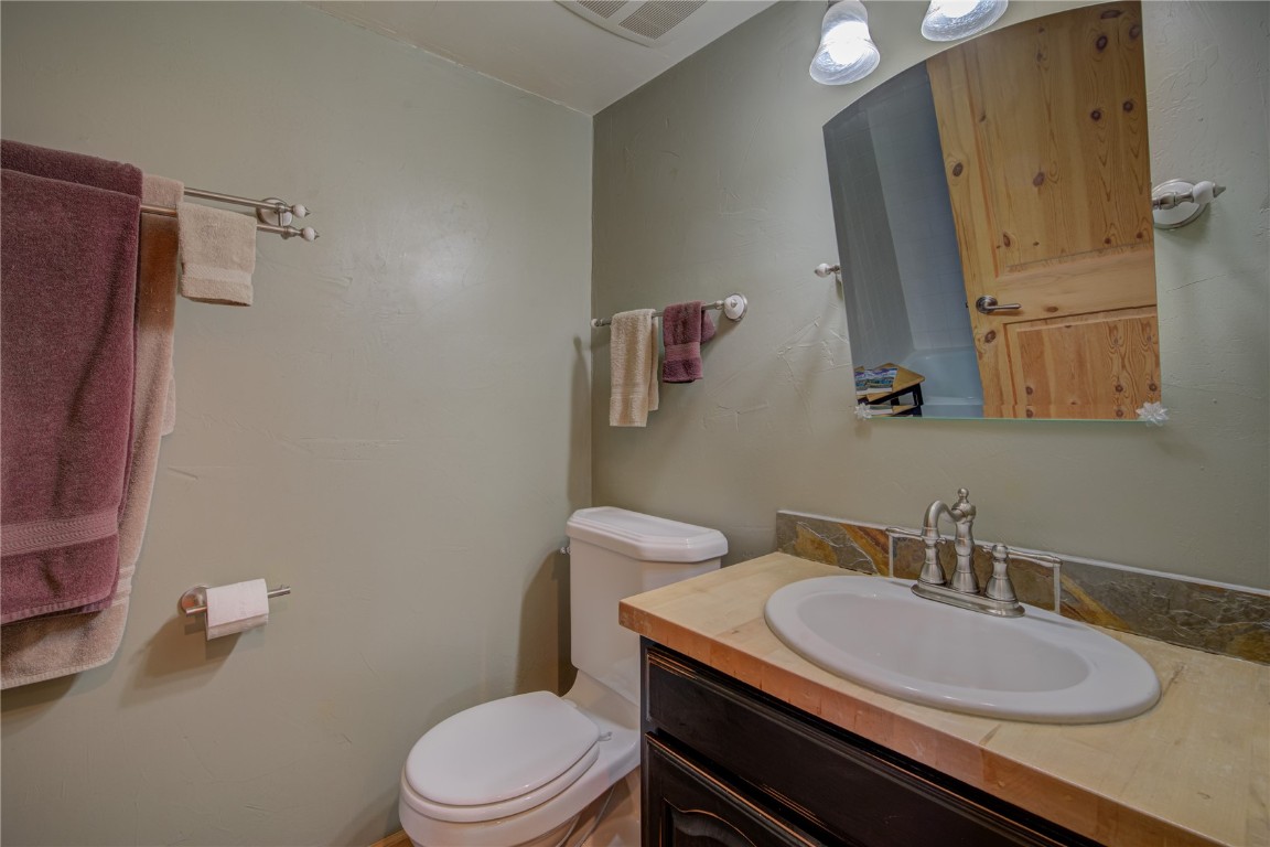 1945 Cornice Road, Unit 2431 Steamboat Springs, CO 80487 - Photo 7 of 24 a bathroom with a granite countertop toilet sink and mirror